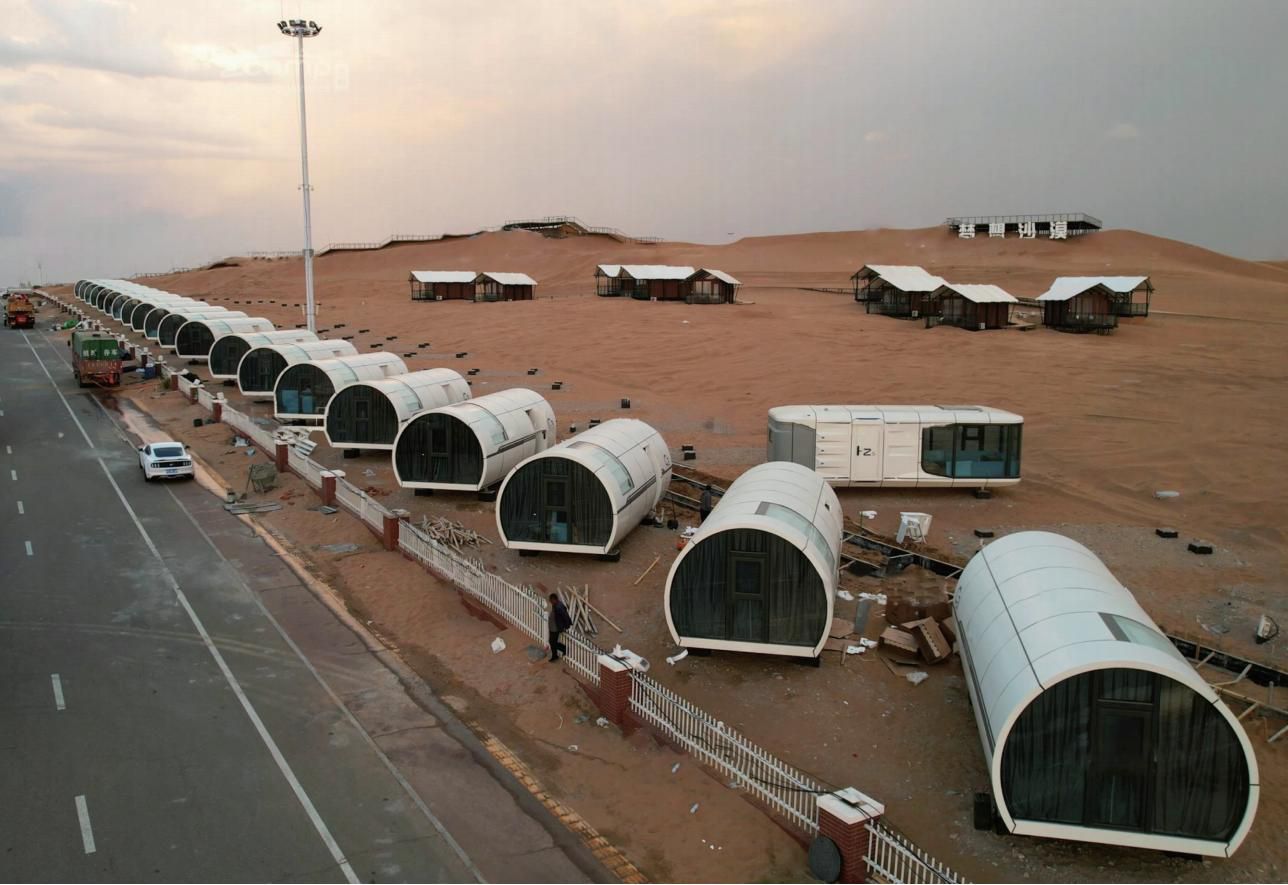 Desert resort deployment with capsule units on sand