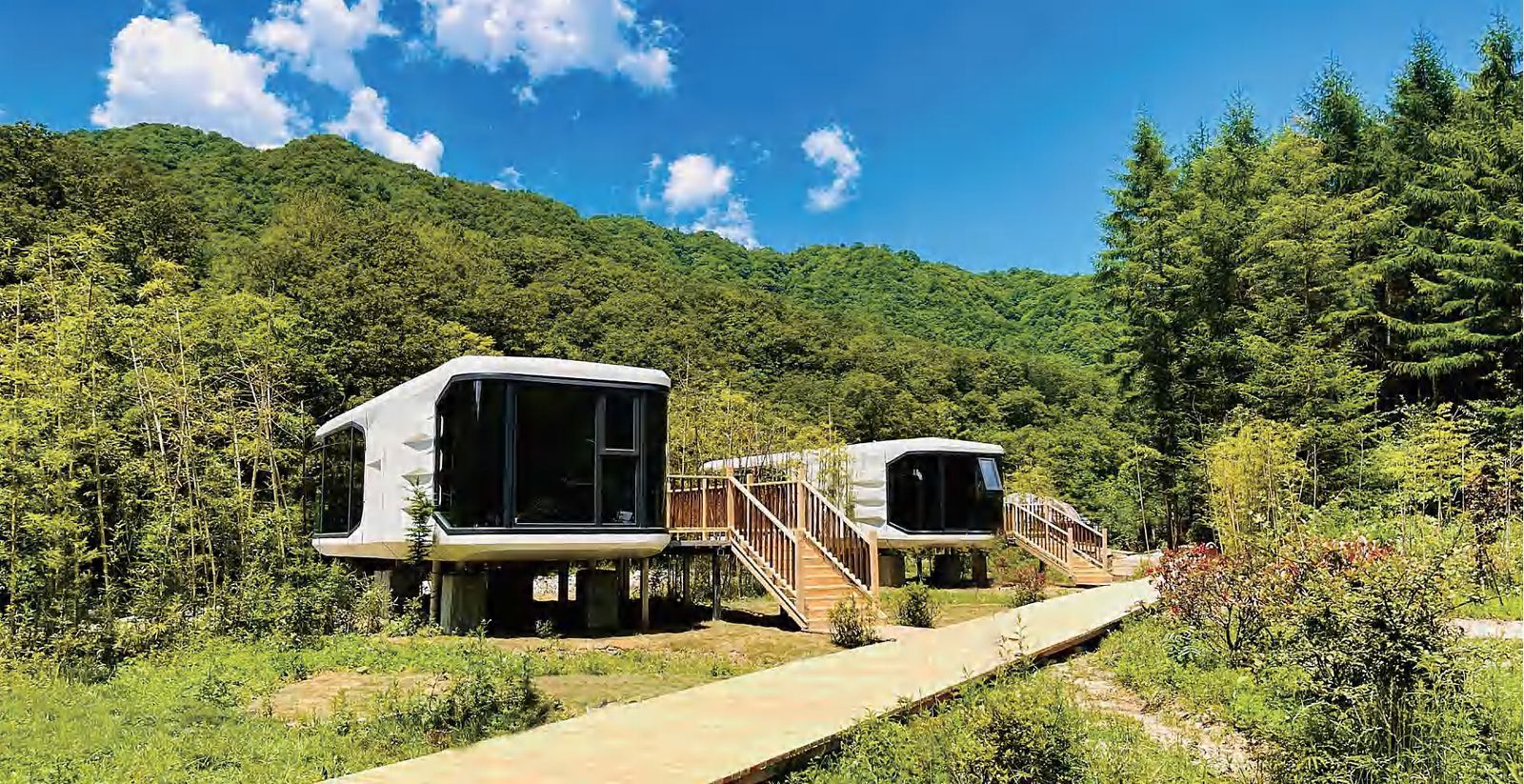 White modular prefab capsule houses in a mountain resort