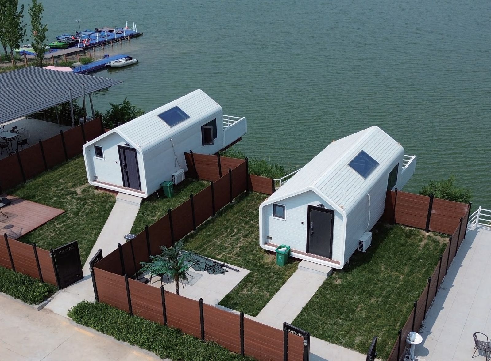 Waterfront modular cabins with white gabled roofs by the lake